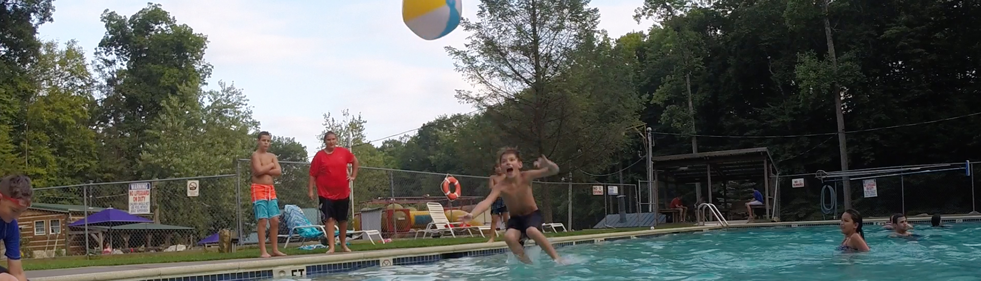 Kid jumping into swimming pool.